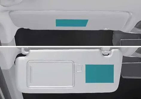 Kia EV2 interior sun visor safety sticker detailing universal airbag hazard warnings for front passengers
