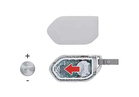 Step-by-step instructional view of opening the Kia EV2 smart key fob housing for internal battery compartment access