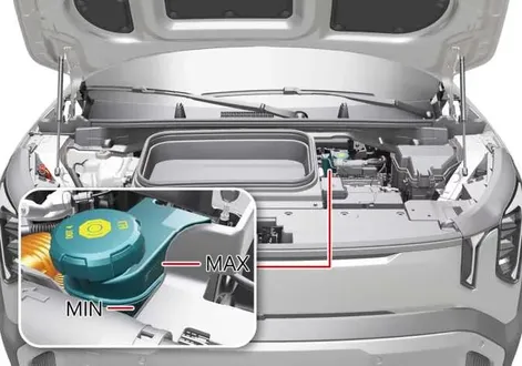Detailed view of a technician examining the brake fluid reservoir fill lines and cap on a Kia EV2