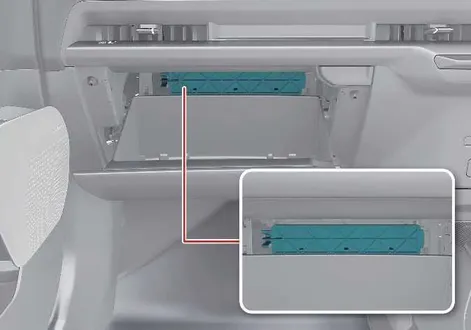 Opening the cabin air filter housing cover behind the glove box of a Kia EV2