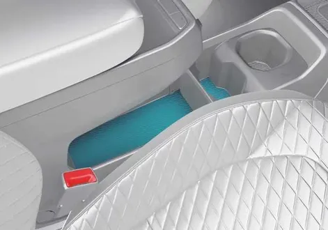 Removable cup holder partition mechanism and adjustment slots inside the storage console of the Kia EV2