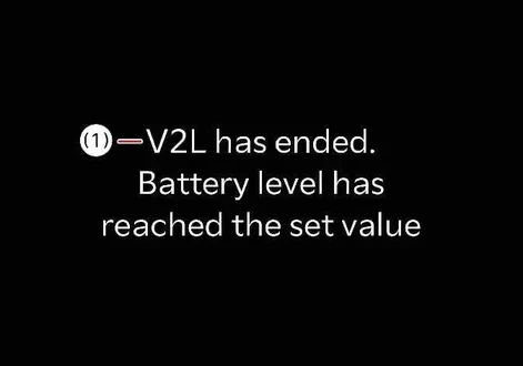 Instrument cluster warning notification indicating V2L power supply has ended because the battery reached the set value in the Kia EV2