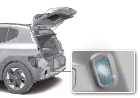 Rear cargo trunk area illuminated by the dedicated luggage compartment light in the Kia EV2