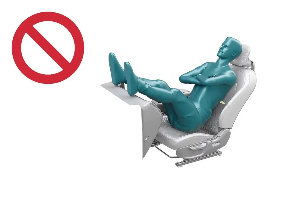 Kia EV2 interior illustration showing unsafe passenger posture with feet on dashboard