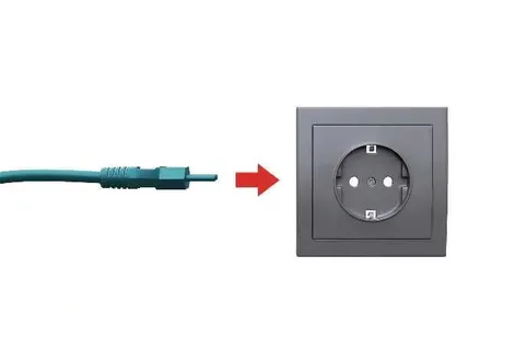 Kia EV2 portable charger plug connected to a standard wall socket