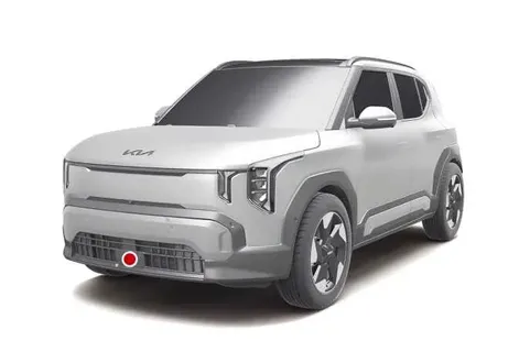 Close-up view of the front radar sensor module located on the lower front bumper of the Kia EV2