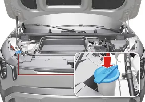 Close-up of the translucent washer fluid reservoir cap and neck under the bonnet of a Kia EV2