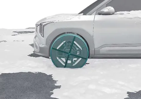 Kia EV2 winter driving guide showing fabric type snow socks mounted on a wheel